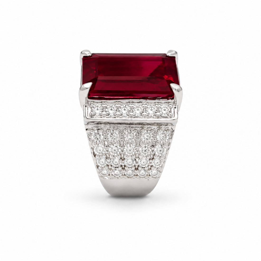 Luxury ring with a large red gemstone and diamond-studded band on a white background