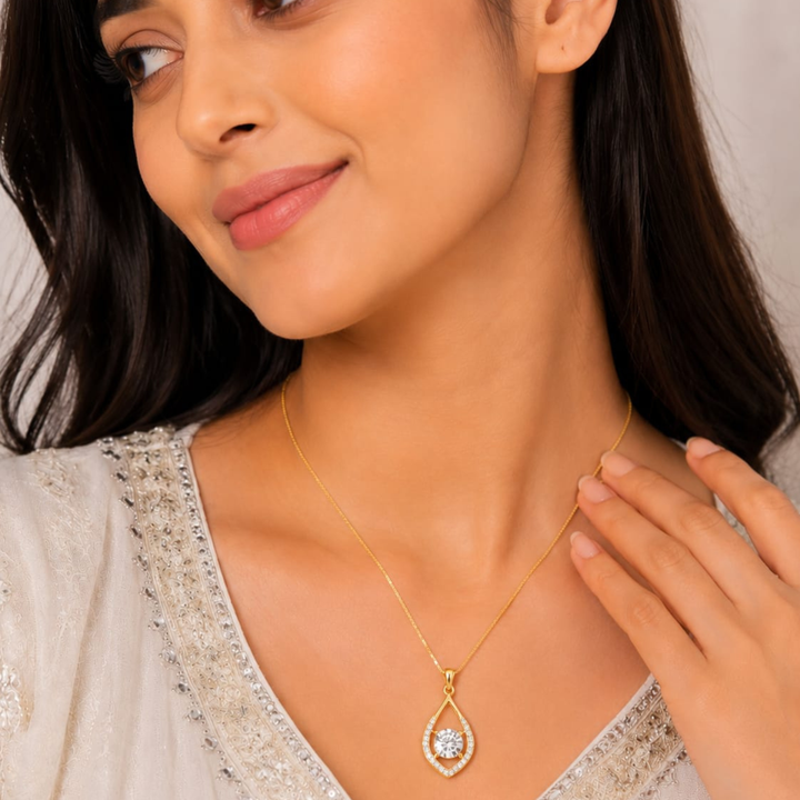 Model wearing Auravelle Drop gold polish pendant necklace with sparkling diamond white stone