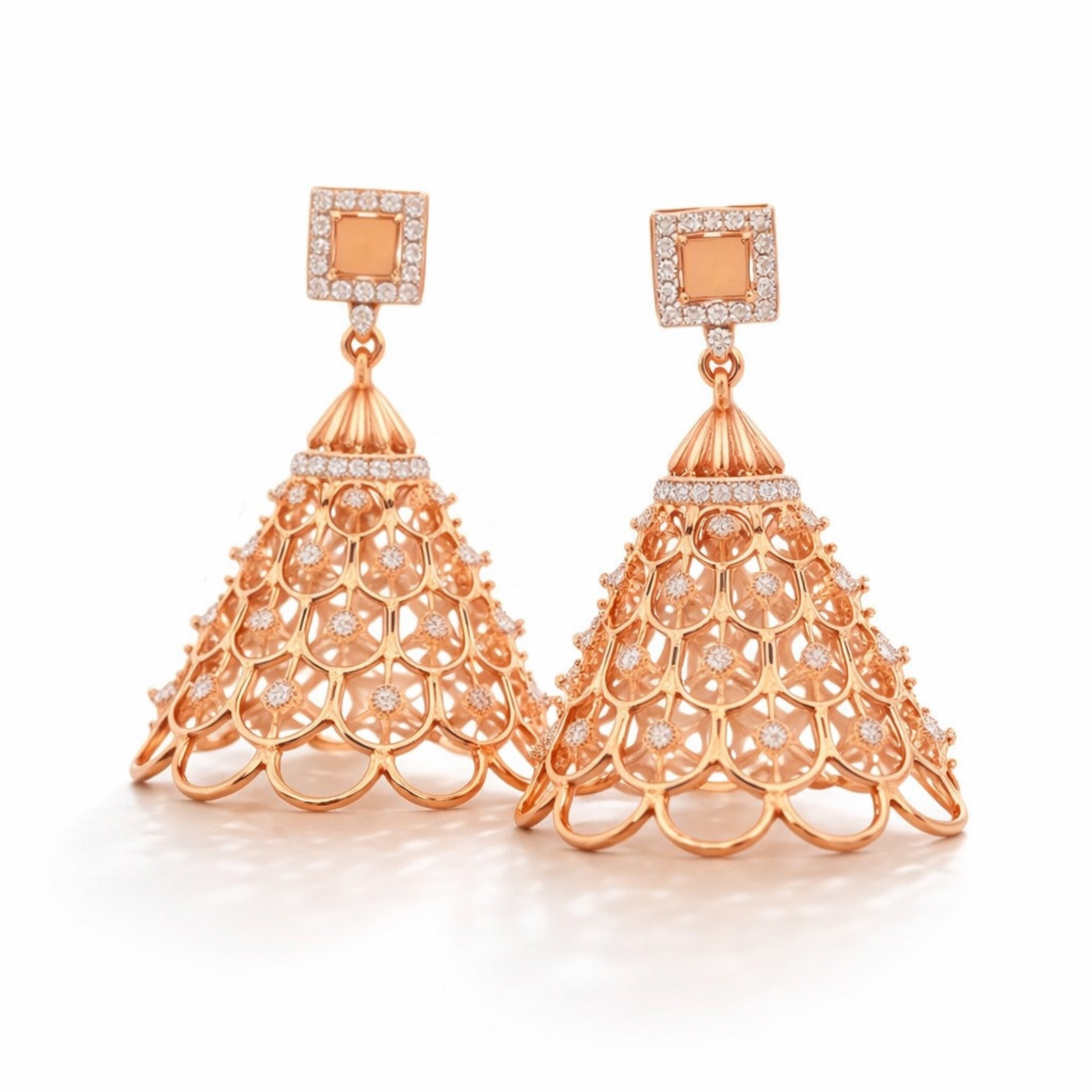 Rose gold earrings with intricate designs on a white background