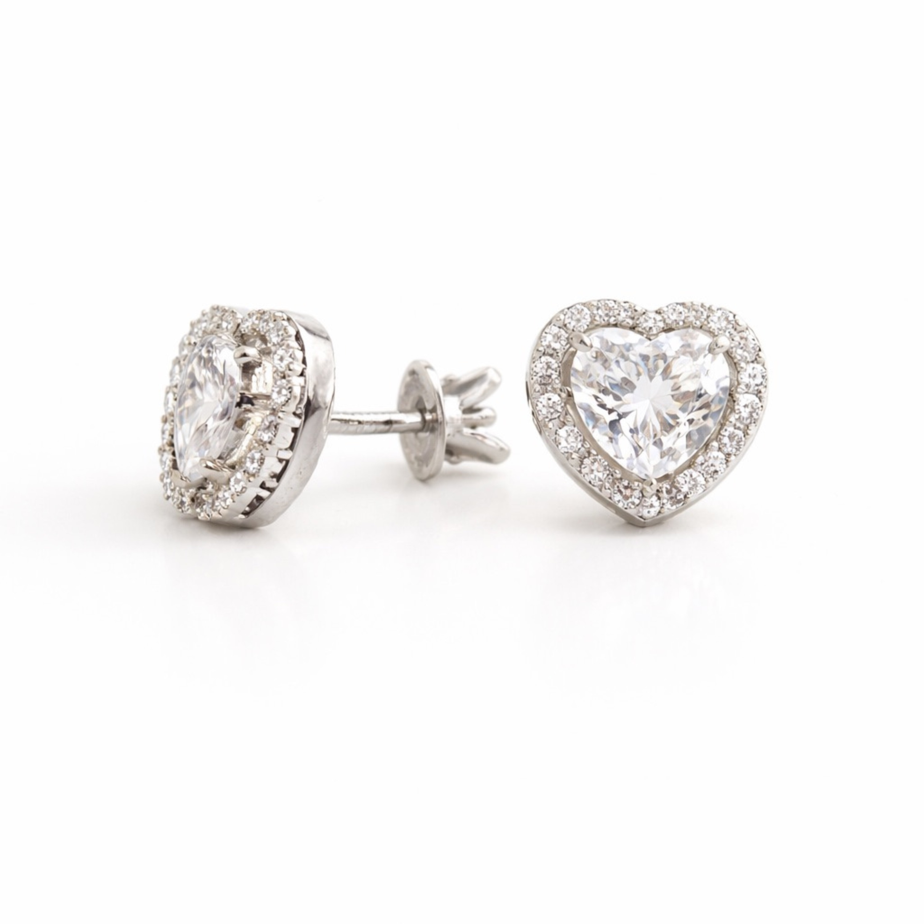 Heart-shaped diamond earrings on a white background side view