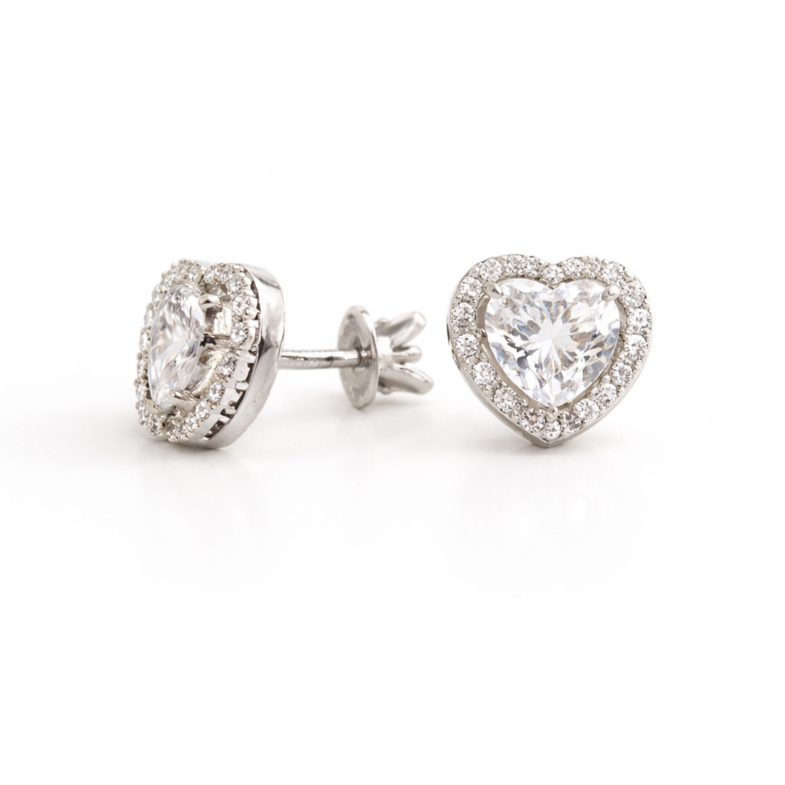 Heart-shaped diamond earrings on a white background side view