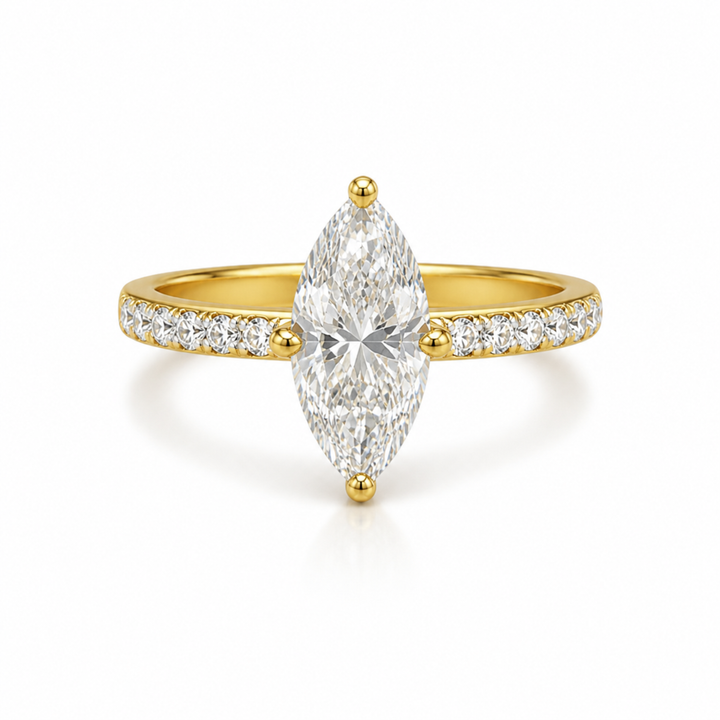 Gold ring with a large pear-shaped diamond and smaller diamonds on the band against a white background