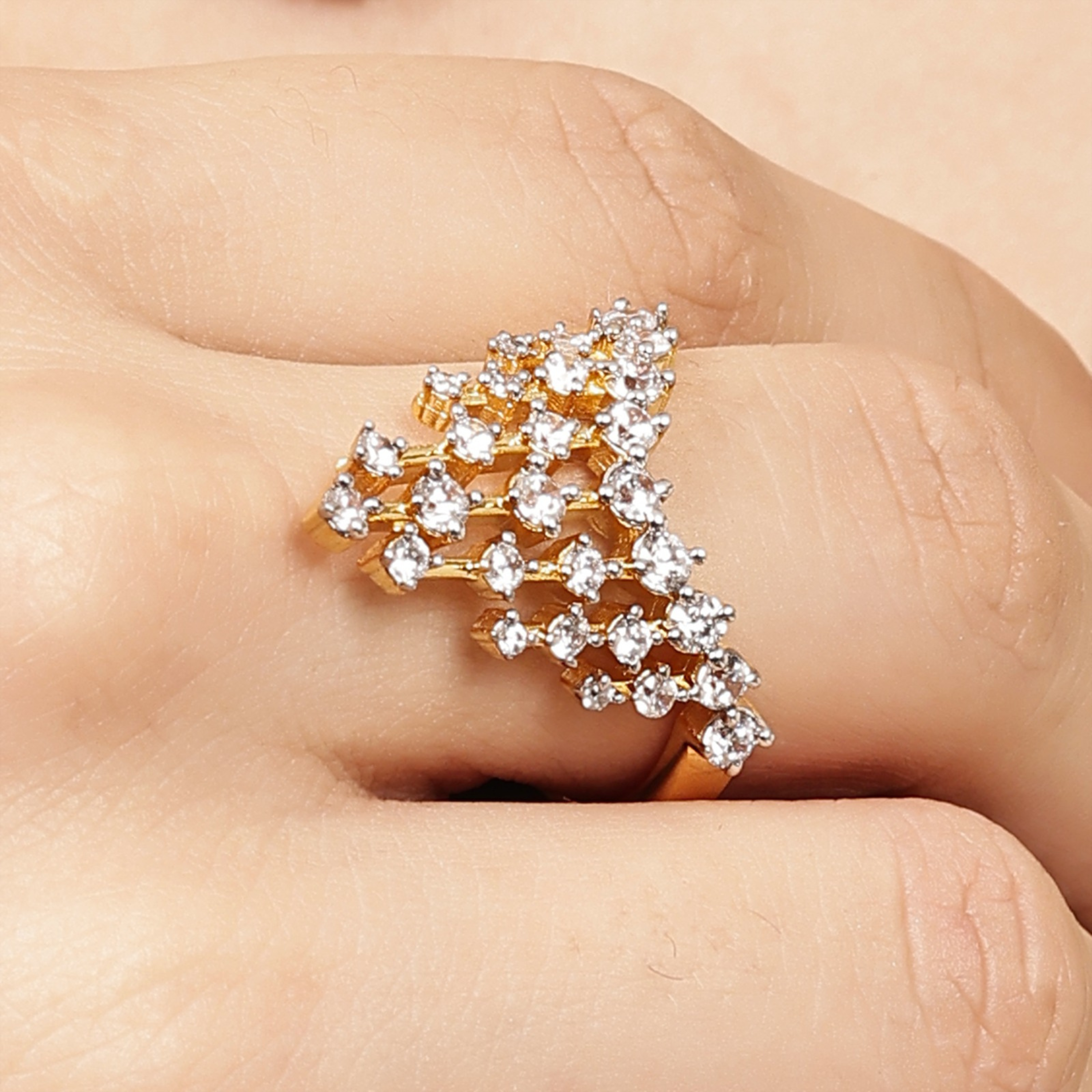 Side angle of A Crown of Brilliance 925 sterling silver crown ring with gold polish worn on hand – Designed2Attract