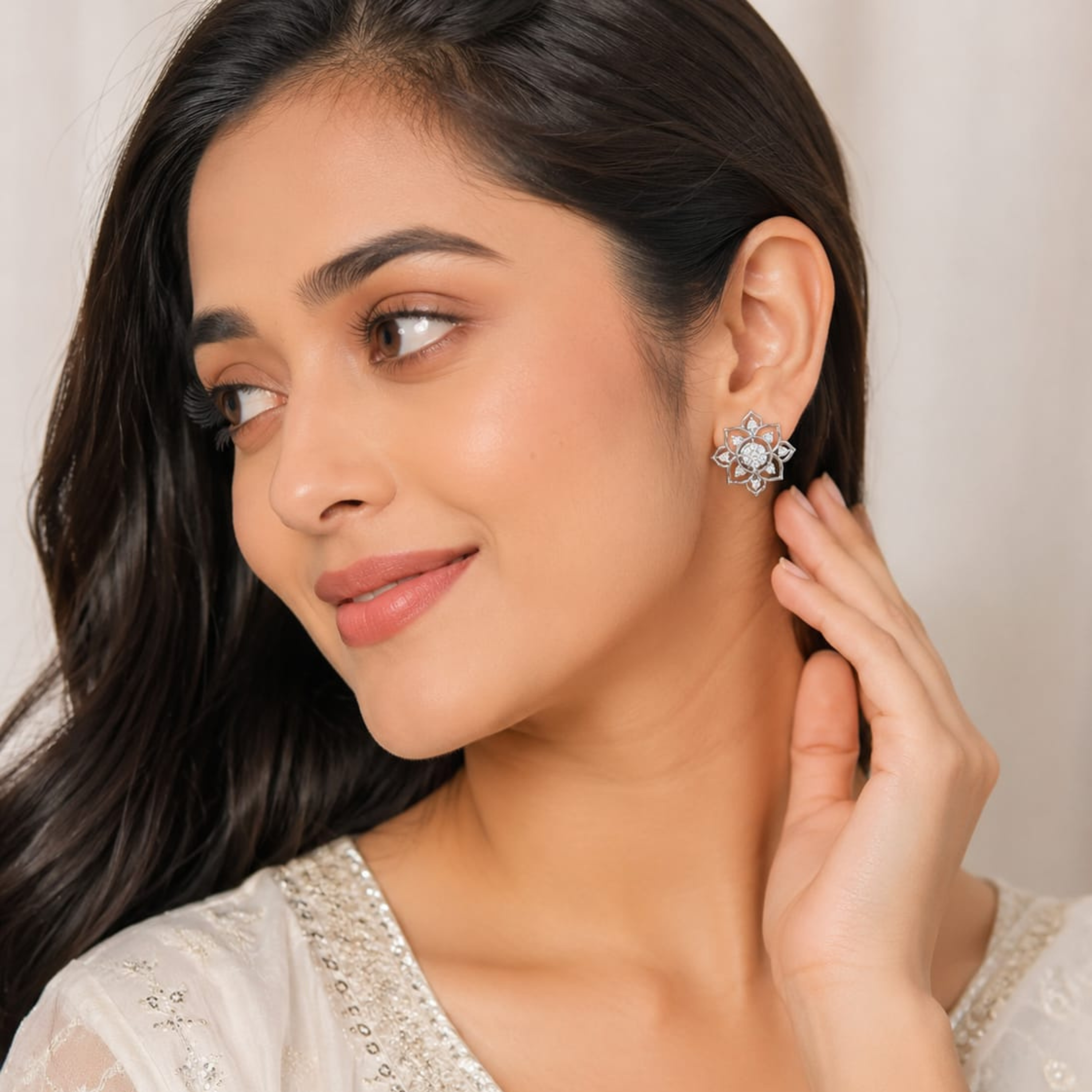 Model wear Aurelia Flora 925 silver stud earrings in white polish with sparkling diamond-like stones on white background