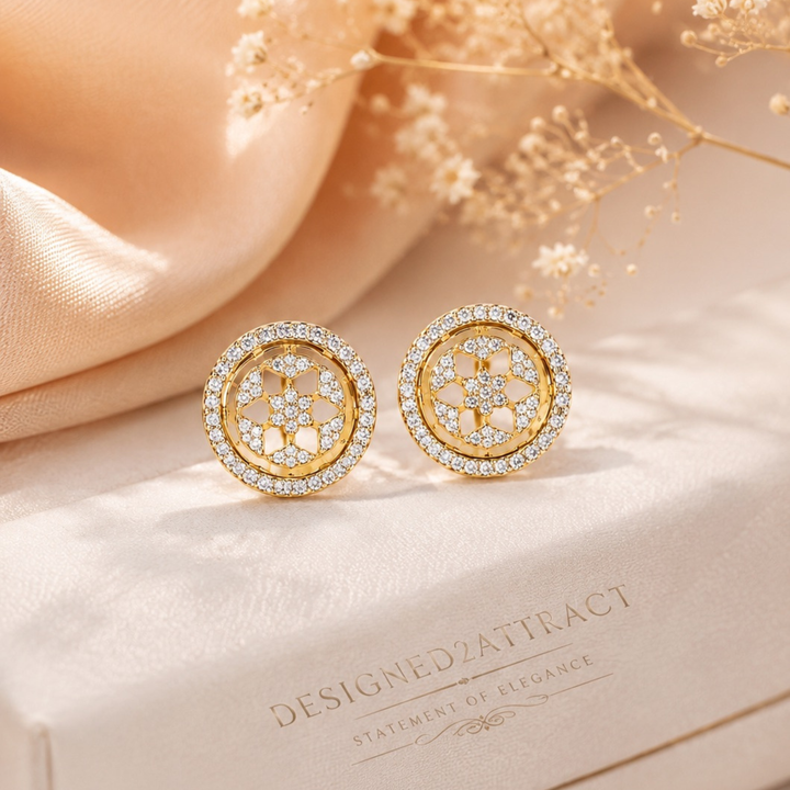 Luxury gold diamond stud earrings displayed with silk fabric and floral aesthetic background