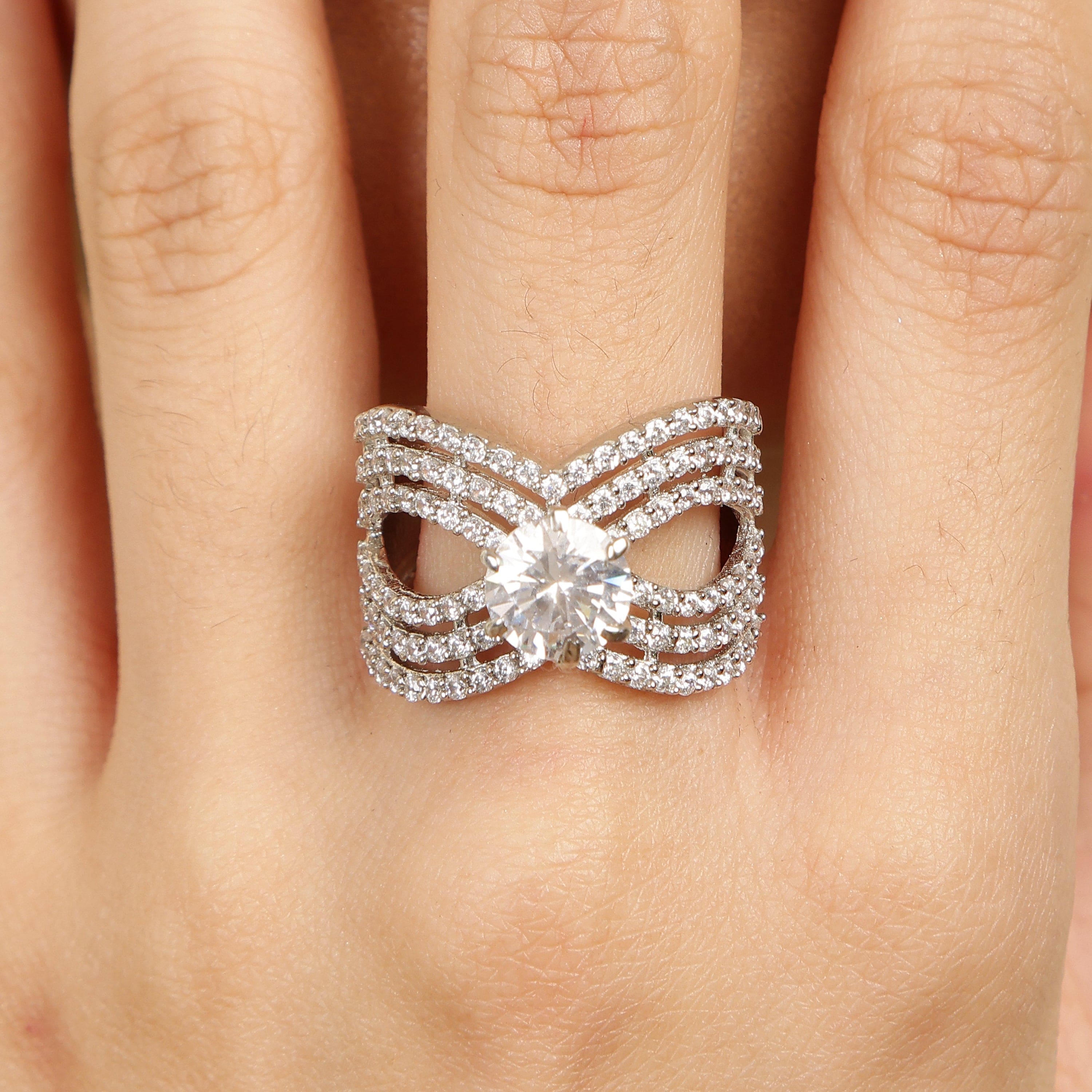 Infinity Tied sterling silver ring worn on hand