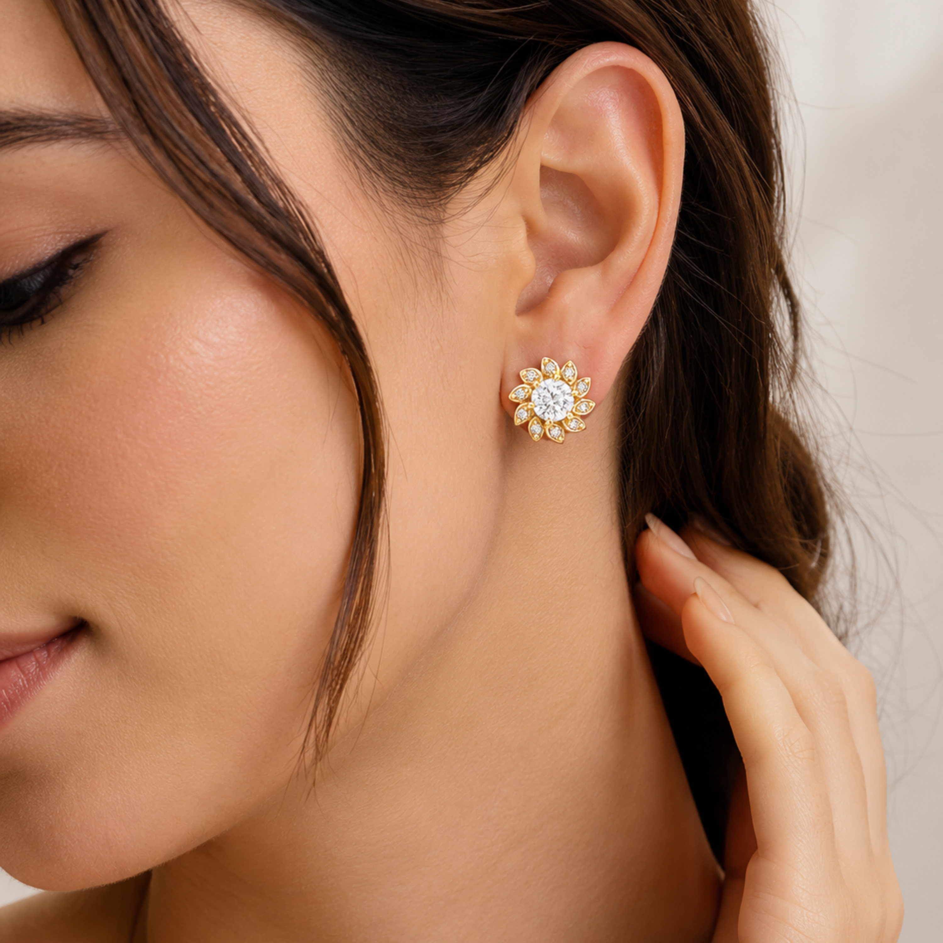 Elegant model wearing gold polish Lunara Spark diamond stud earrings with sparkling white stones realistic close up look