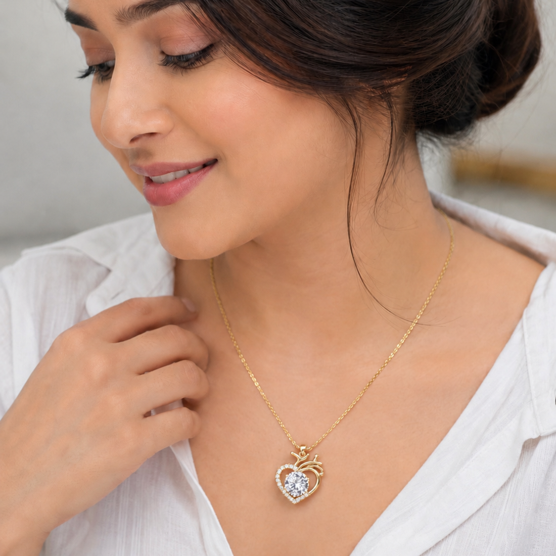 Beautiful model wearing elegant heart shape gold polish pendant necklace with sparkling diamond look stone