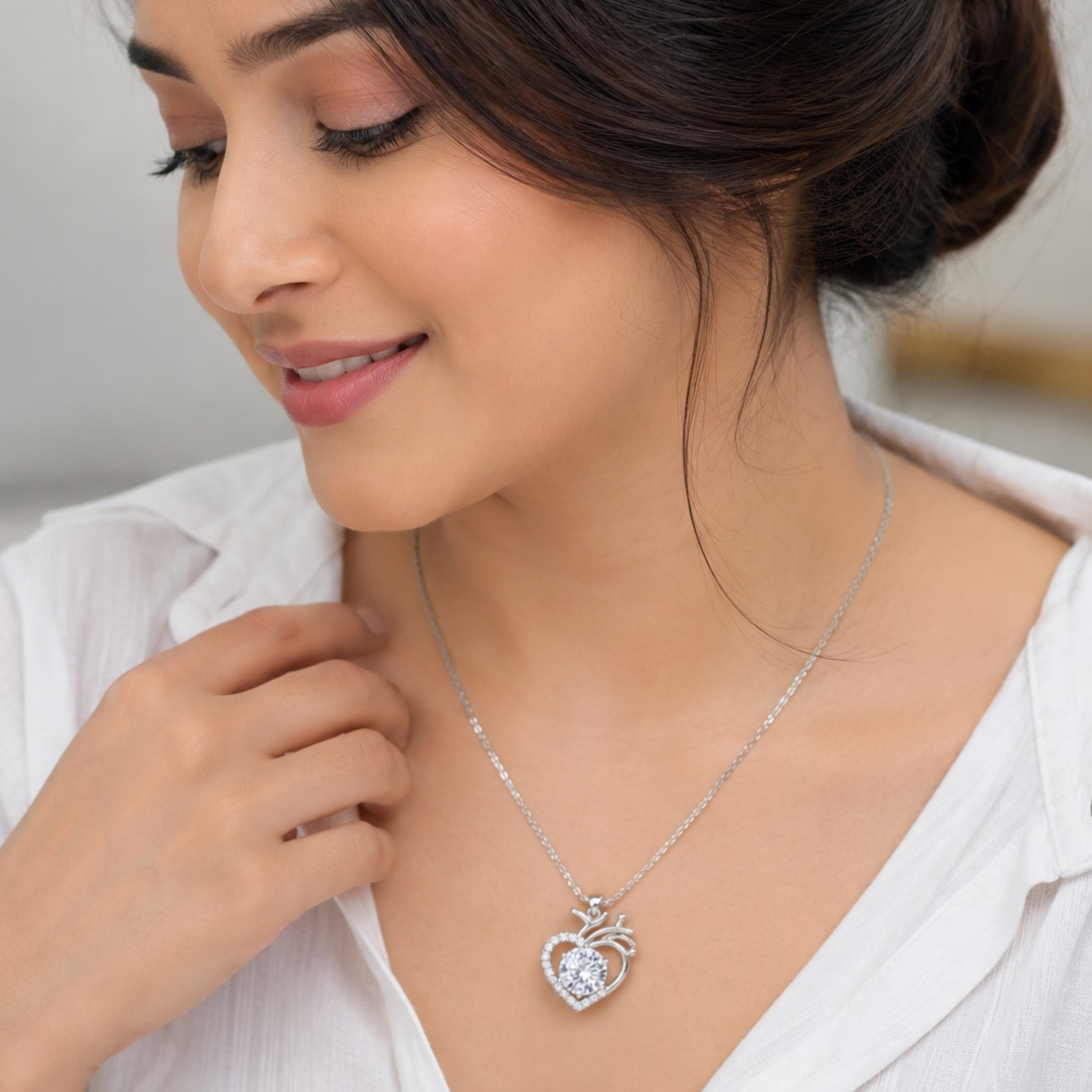Beautiful model wearing elegant heart shape white polish pendant necklace with sparkling diamond look stone