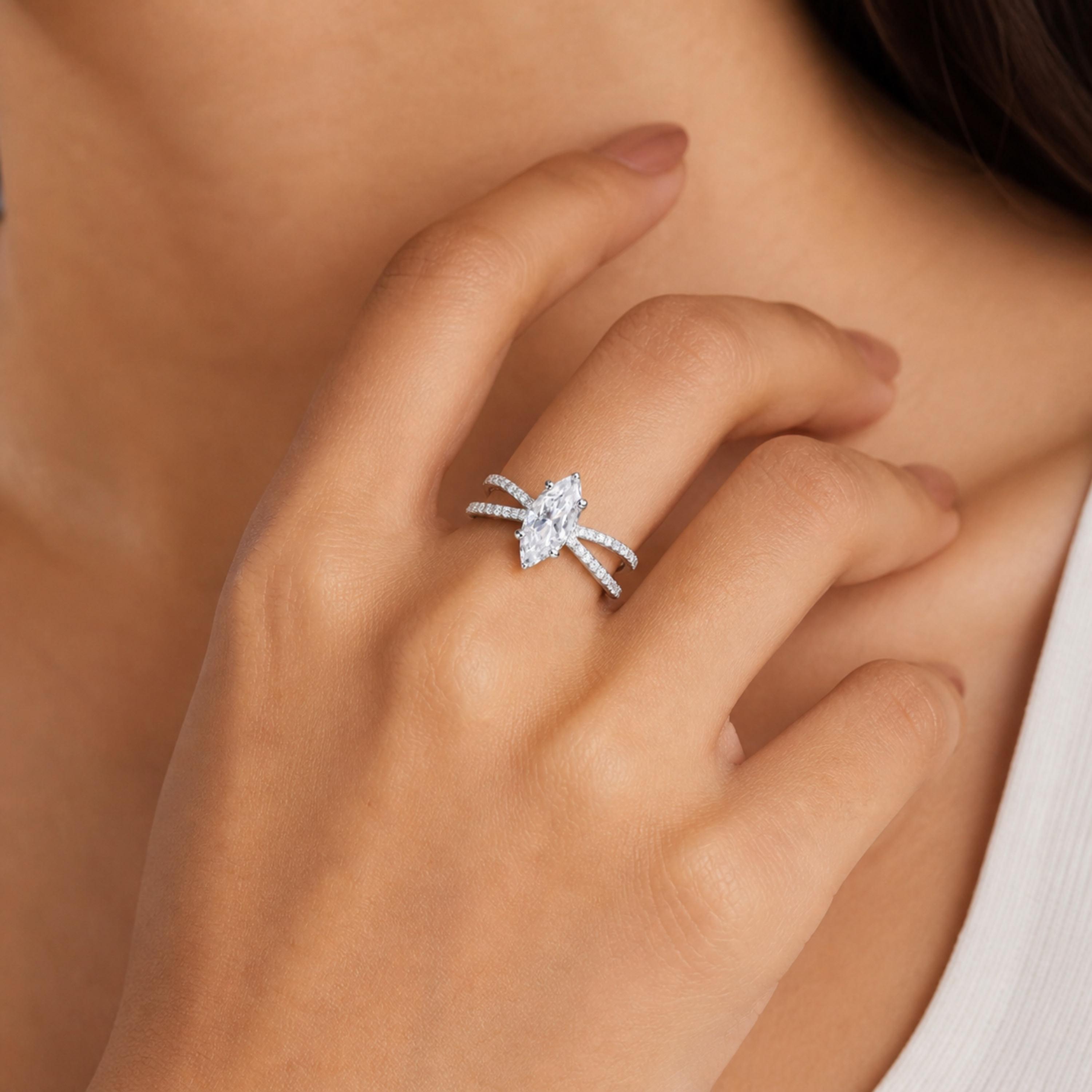     Close-up of marquise diamond ring with pavé band in white polish