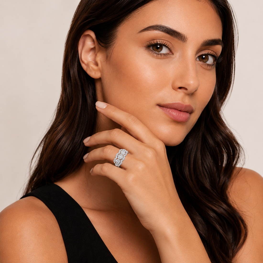 Woman wearing a diamond ring on a neutral background