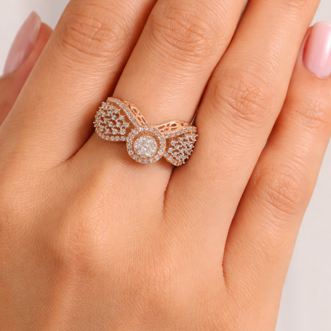 Close-up of the Radiant Blush rose gold-plated 925 Sterling Silver halo CZ ring worn by a model, highlighting its sparkling design