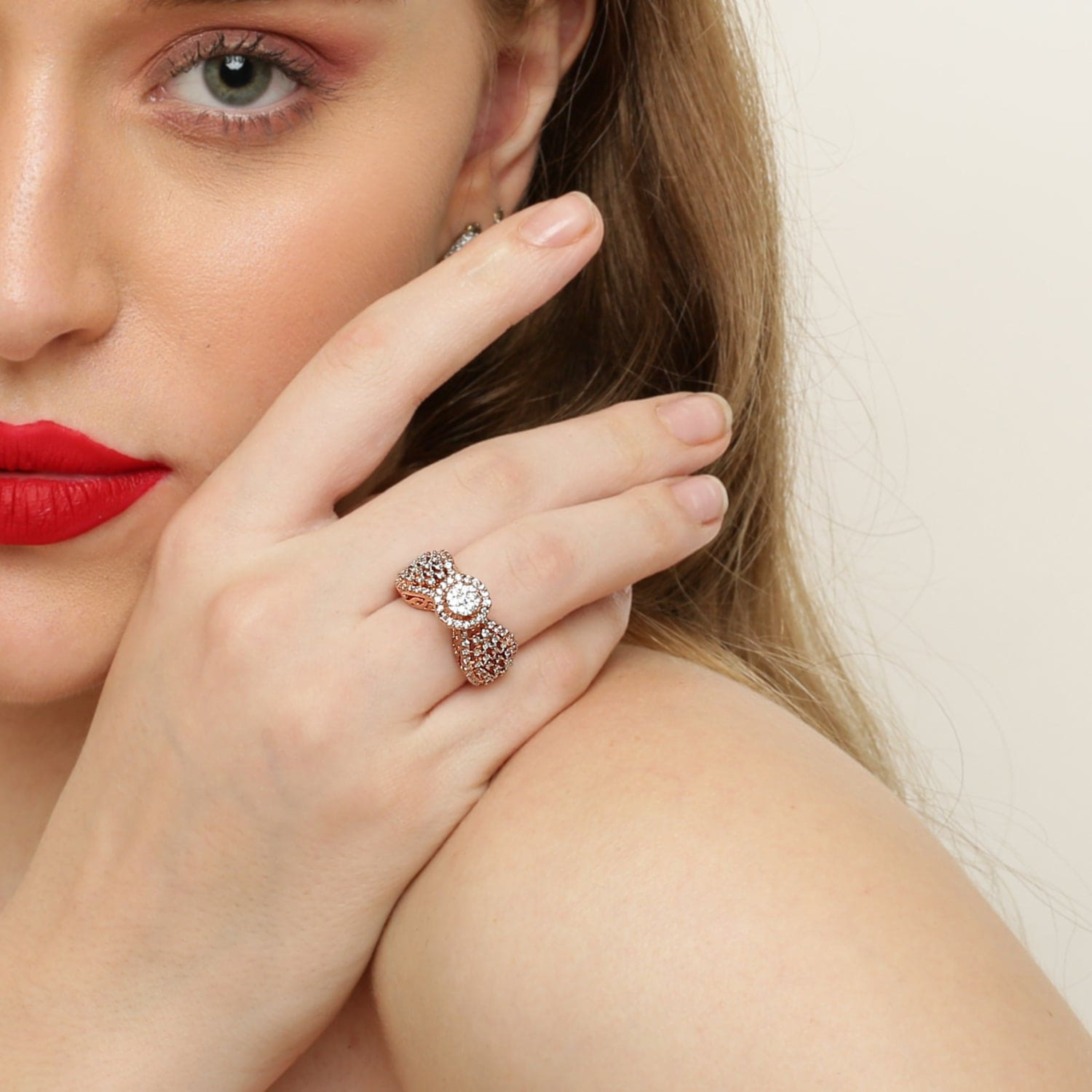 Model wearing the Radiant Blush rose gold-plated 925 Sterling Silver halo CZ ring in an elegant front hand pose.