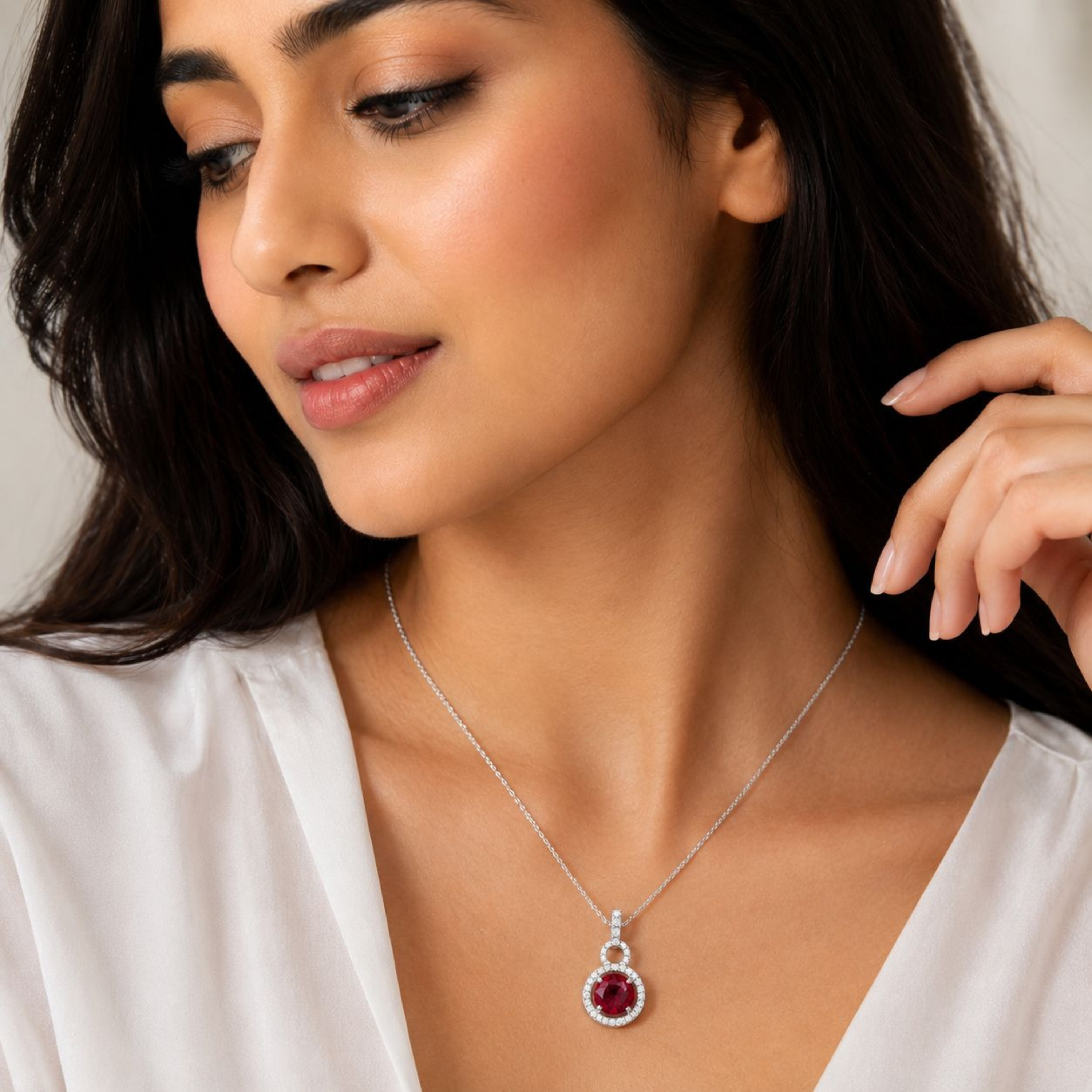     Elegant ruby halo pendant necklace in sterling silver worn for premium jewellery styling