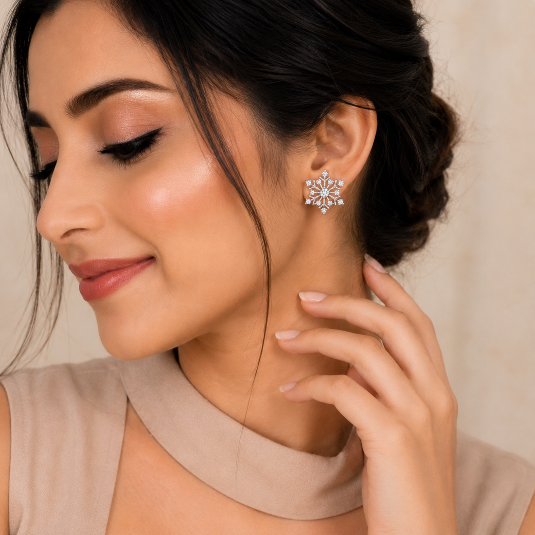 Elegant model wearing white polish snowflake stud earrings with sparkling white stones, realistic jewellery website model image