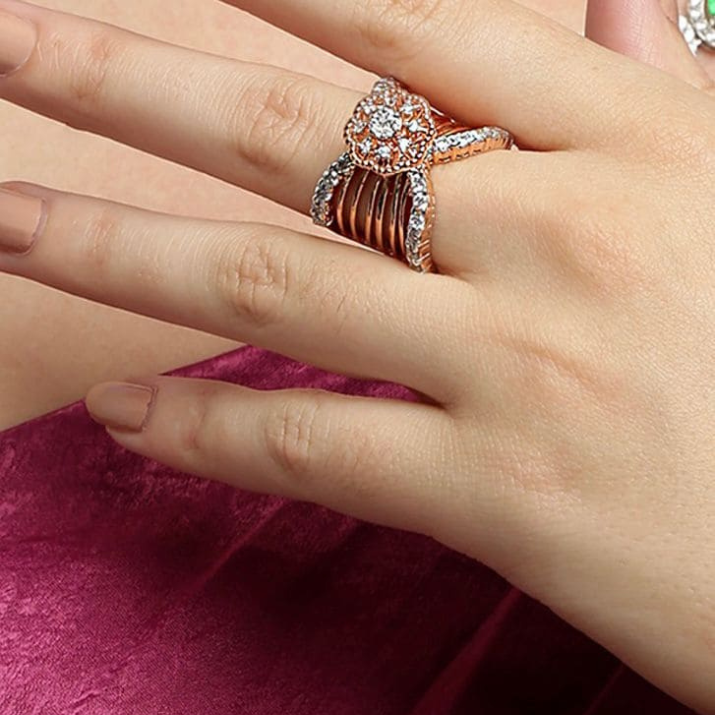 Beautiful woman hand wearing 925 sterling silver rose gold diamond statement ring by Designed2Attract